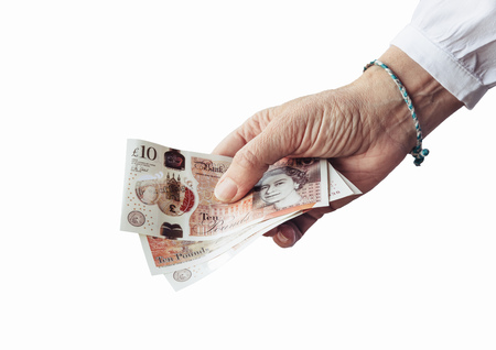 Woman holding pounds sterlings isolated on white background