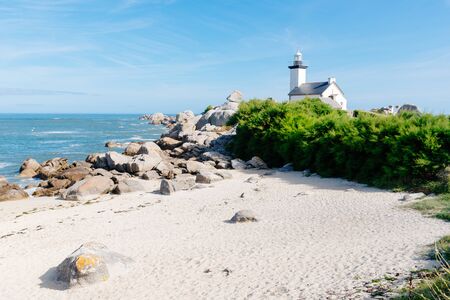 Scenic view of beach and lighthouse in Brittanyの写真素材