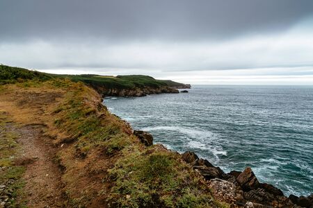 Scenic view of cliffs and sea against skyの写真素材