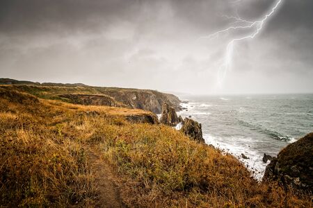 Lightning bolt strike from a thunderstorm near the sea