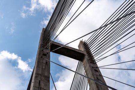 Modern suspension bridge. Detail of tower and steel cables