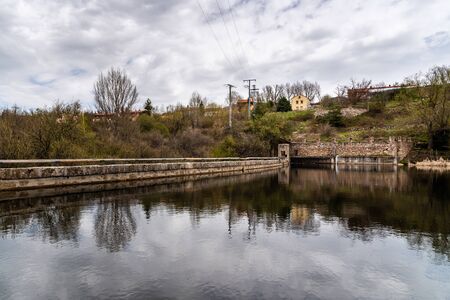 Scenic view of dam and reflections on the water. River Eresma