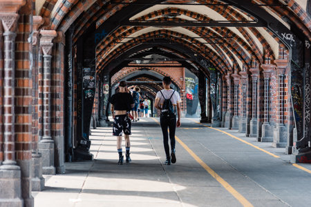 Unidentified alternative people crossing Oberbaum Bridge over Spree river in Berlinのeditorial素材