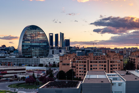 View of the skyline of Madrid with BBVA office building and Cuatro Torres financial district at sunsetのeditorial素材