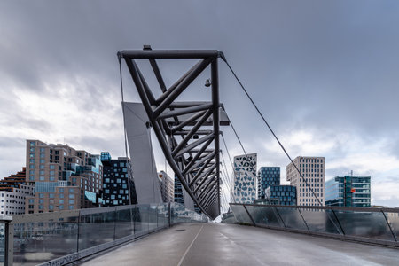 Cityscape of Barcode Project area with Akrobaten pedestrian bridge over railroad in Osloのeditorial素材