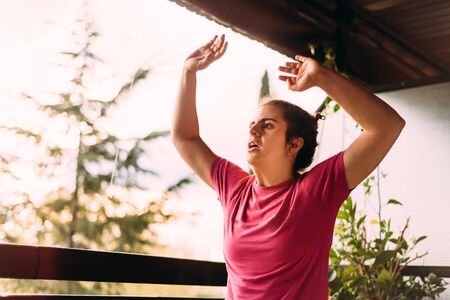 Young woman doing fitness workout at home during quarantine confinement