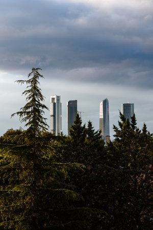 Urban landscape of Madrid with Cuatro Torres financial district skyscrapers emerging from a mass of treesのeditorial素材