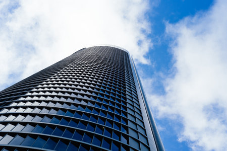 Low angle view of office building in the city of Madrid against blue sky