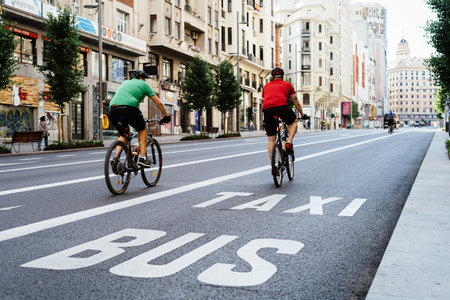 Cyclists riding on an empty Gran Via Avenue during Covid-19 pandemic lockdown in Madridのeditorial素材