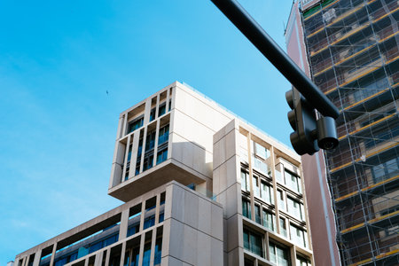 Low angle view against sky of modern building in famous Gran Via Avenue of Madrid