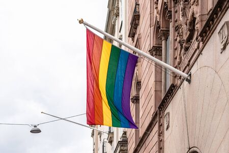 Gay pride rainbow flag hanging on public buildingの写真素材