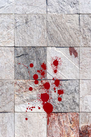 Red blood splatter on stone wall