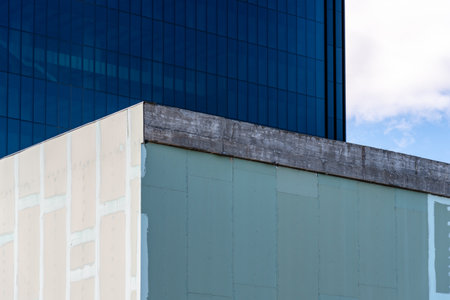 Building with sheating board facade under constructionの写真素材