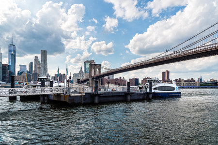 Pier in East River Against Cityscape of Downtown of Manhattan and Brooklyn Bridgeのeditorial素材