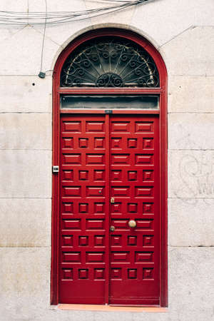 Red Entrance Door to Residential Building with Stone Facadeの写真素材