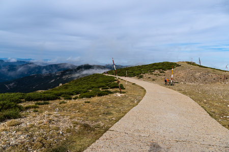 Cyclist fixing flat tire at the top of the mountain roadのeditorial素材