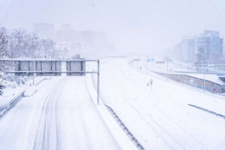 View of a highway in the city covered in snow during heavy snowfallの写真素材