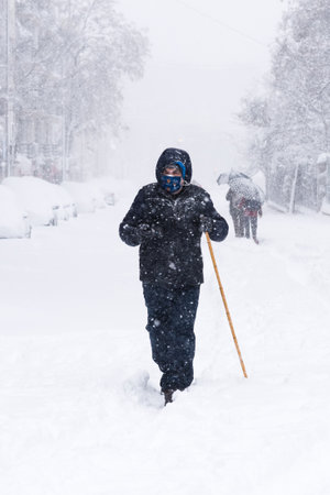 People on a city street covered in snow during heavy snowfall storm in Madridのeditorial素材