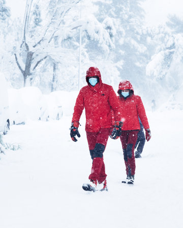 People on a city street covered in snow during heavy snowfall storm in Madridのeditorial素材