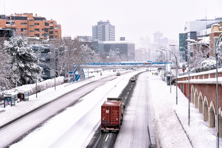 highway covered in snow with trapped cars during heavy snowfall storm Filomena in Madridのeditorial素材