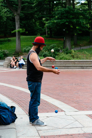 Juggler doing tricks with balls in Central Park in New York Cityのeditorial素材