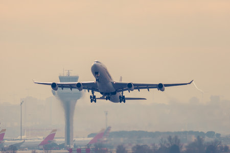Airbus A340-300 passenger aircraft of the airline Plus Ultra taking off the airport in a foggy dayのeditorial素材