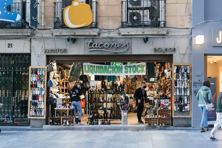 Shoe store window display in Preciados Street in Madrid with a sign advertising salesのeditorial素材