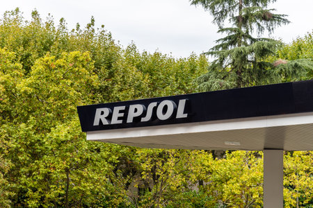 Repsol gas station sign against green trees backgroundのeditorial素材