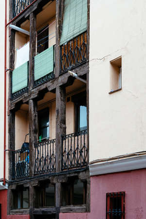 Low angle view of old cast iron balconies of old residential building in Lavapies quarter in Madridの写真素材