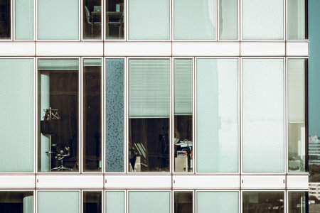 Full frame view of the curtain glass facade of a modern office building in Amsterdam