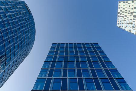 Low angle view of modern office buildings against sky in Amsterdamのeditorial素材