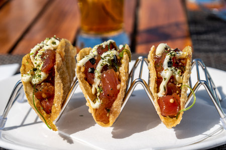 Mexican tacos with beef, tomatoes, chilli and onions in restaurantの写真素材