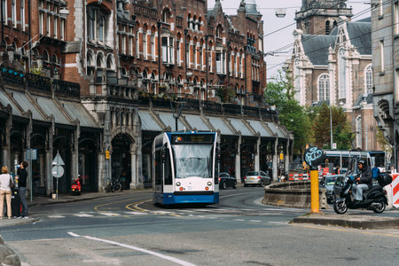 Tram speeding up Raadhuisstraat street in the historic centre of Amsterdamのeditorial素材