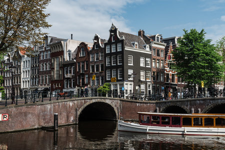 Scenic view of the waterfront of canal with typical Dutch houses in Amsterdamのeditorial素材