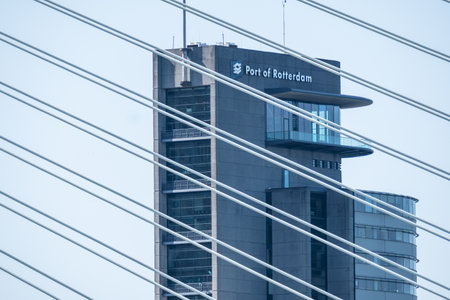 Iconic skyscraper and bridge against sky in Rotterdamのeditorial素材
