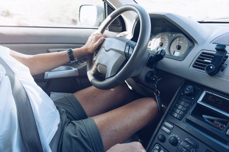 Close-up of woman driving a car by the road. Interior view