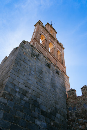 The Roman Walls of Avila a sunny summer day. Gate with gable