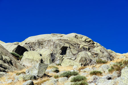 Beautiful landscape of rocks on a meadow in Gredos Park in Spain under a blue sky