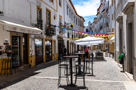 Narrow street in the old town of Evora with restaurant terraceのeditorial素材