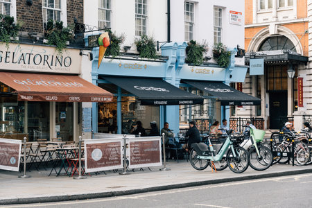 London, UK - August 25, 2023: Unknown people enjoy a breakfast sitting on the terrace of a cafe near Covent Garden.のeditorial素材
