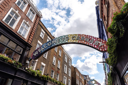 London, UK - August 27, 2023: View of Carnaby Street. It is a pedestrianized shopping street in Soho in the City of Westminster. Sign over the streetのeditorial素材