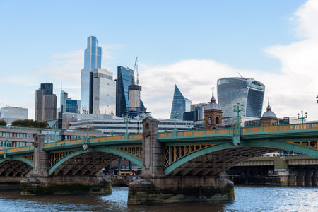 LONDON, UK - August 26, 2023: Southwark Bridge over Thames River against skyscrapers in the City of London. View at duskのeditorial素材