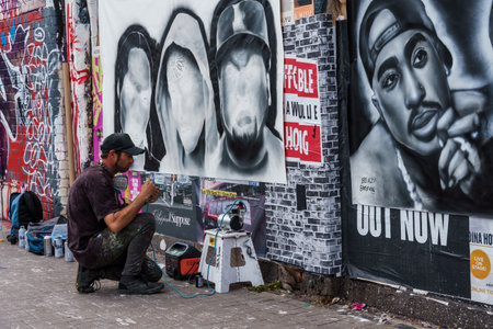 London, UK - August 25, 2023: Artist painting graffiti on the wall in Brick Lane in Shoreditch in the East Endのeditorial素材