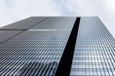 Tokyo, Japan - August 08, 2024: Low angle view of office buildings in Toranomon Hills area against sky.のeditorial素材
