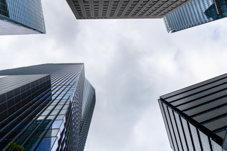 Tokyo, Japan - August 08, 2024: Low angle view of office buildings in Toranomon Hills area against sky.のeditorial素材