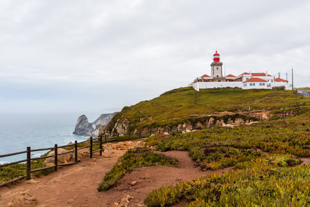Overcast day at the westernmost point of continental Europe, the lighthouse at Cape Roca, Portugal, stands tall.の写真素材