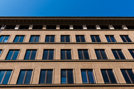 A symmetrical facade under a clear blue sky creates a striking architectural scene in Helsinki, Finland.の写真素材