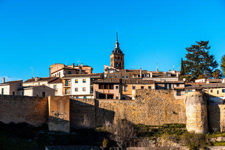 Panoramic view of the historic city of Segovia, Spain, with its ancient walls under a clear sky.の写真素材