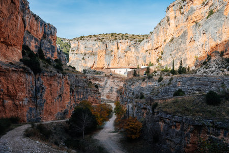 Sanctuary of Our Lady of Jaraba built into the rock face of River Mesa canyon, highlighting ancient...