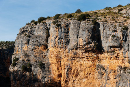 River Mesa canyon revealing ancient rock layers forming dramatic cliffs and natural landscape under...